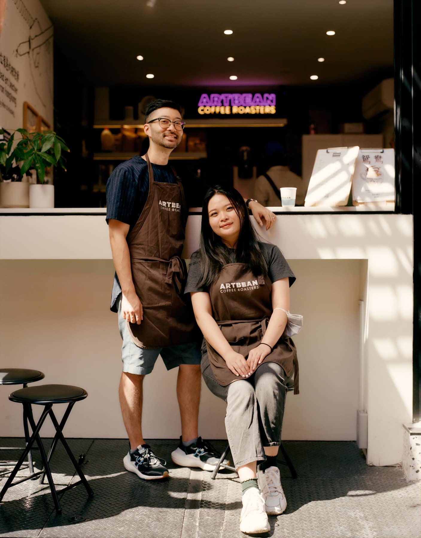 Two owners in aprons at the counter of their coffee roastery