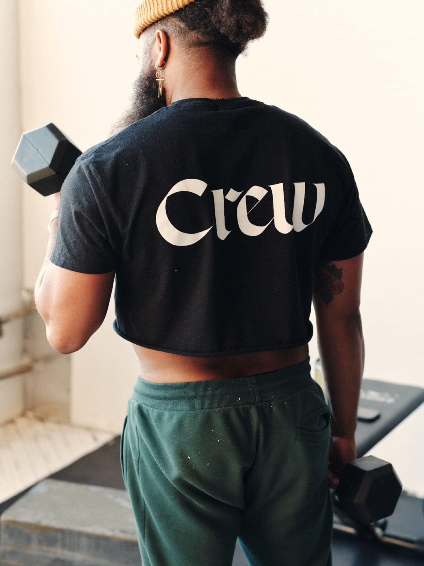The back of the Crew tee, lifting a dumbbell