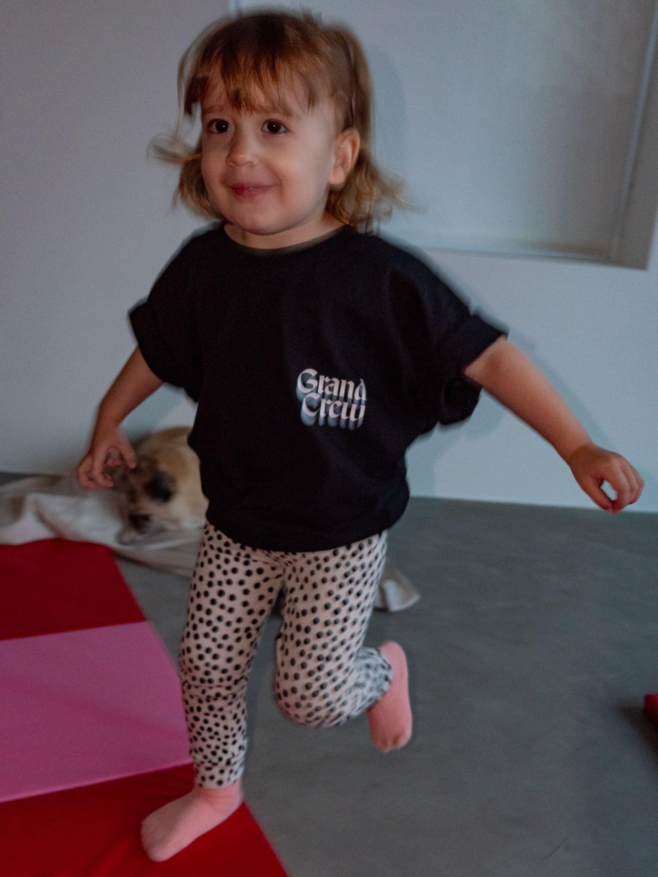 A toddler running in the kids crewneck