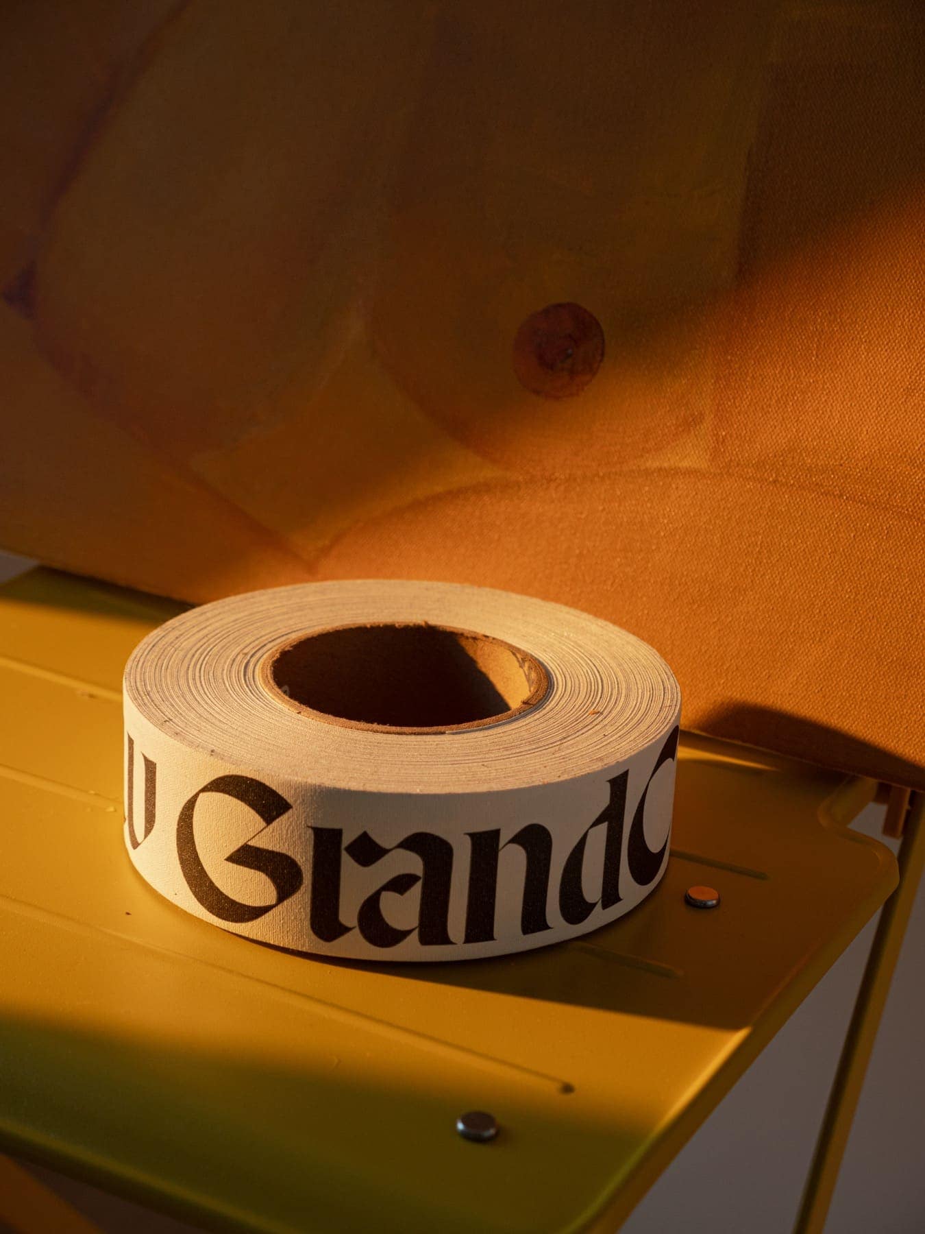 A roll of Grand Crew tape on a desk