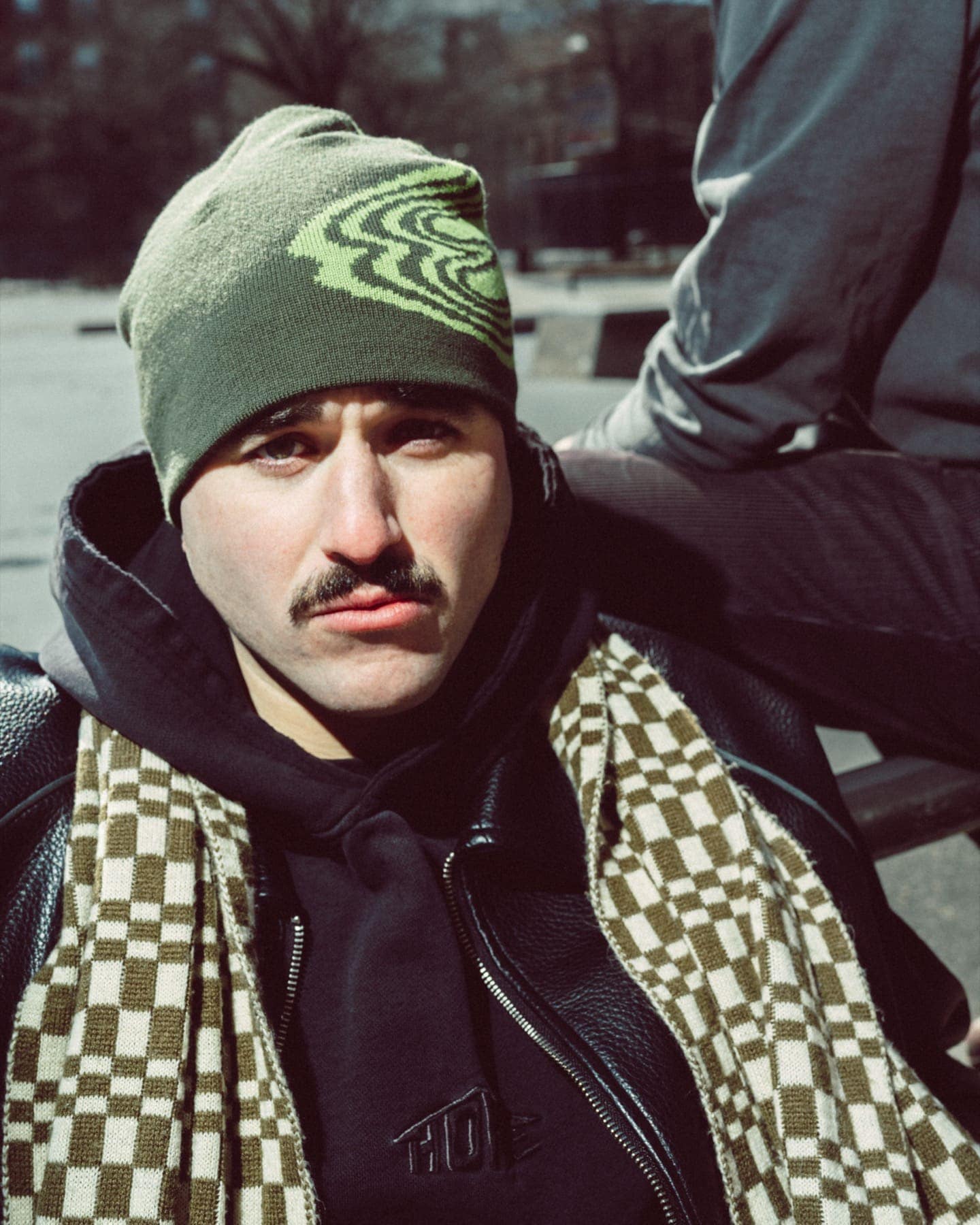 Portrait in the green GCXC beanie and a checked scarf