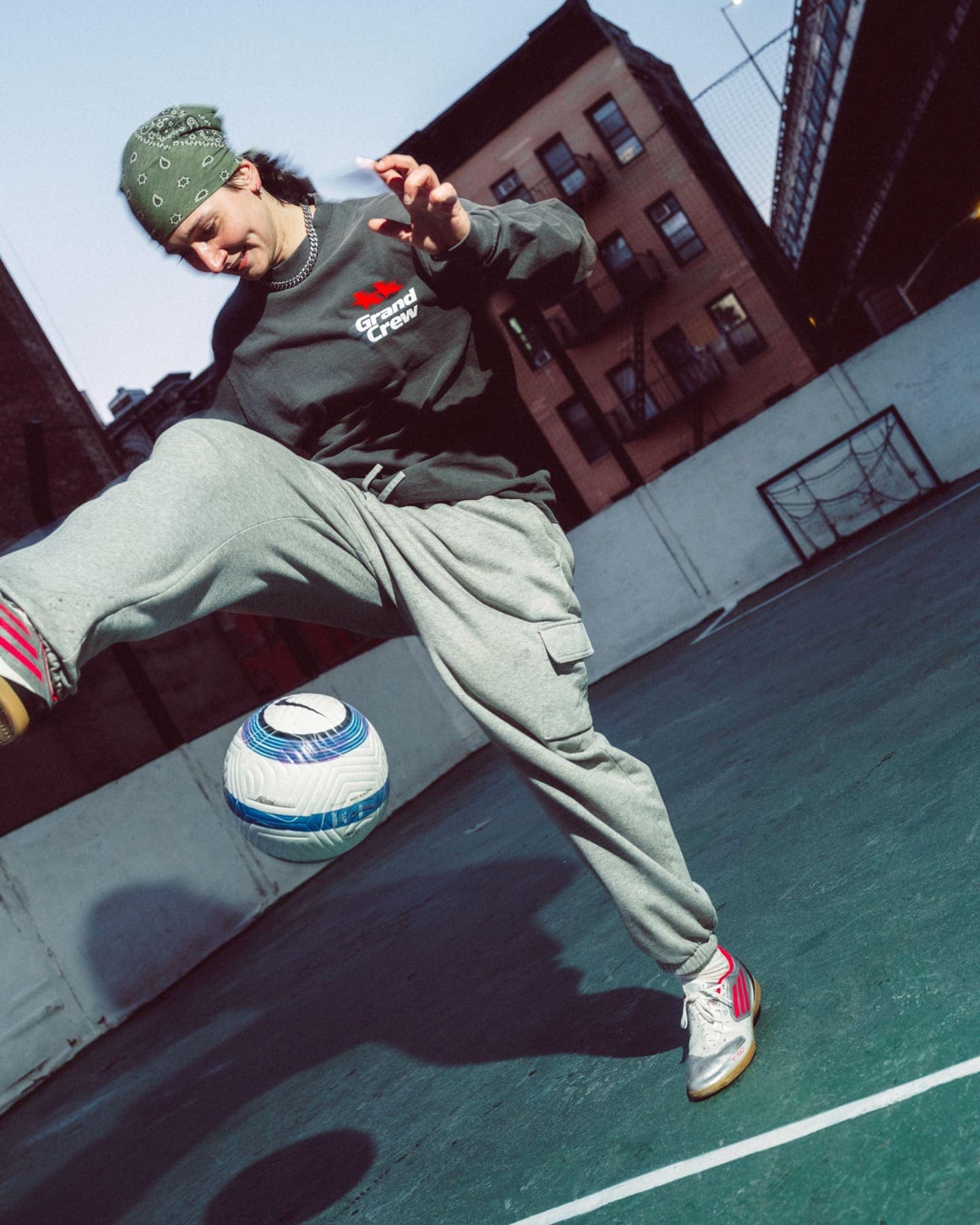 Kicking a ball on a rooftop pitch in the long sleeve