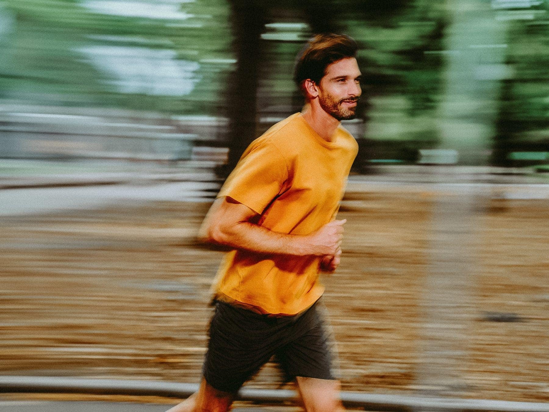 A runner mid-stride in a park