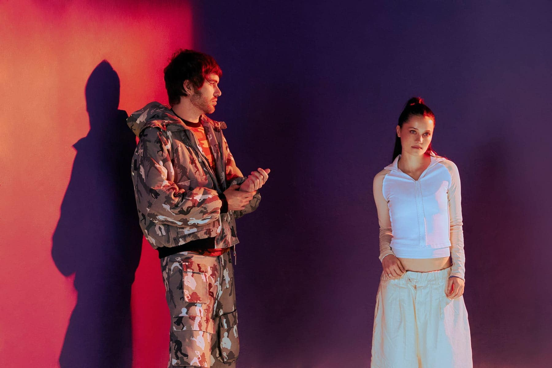 Shanny Wise and Jackson Walker Lewis standing in front of a red and purple wall