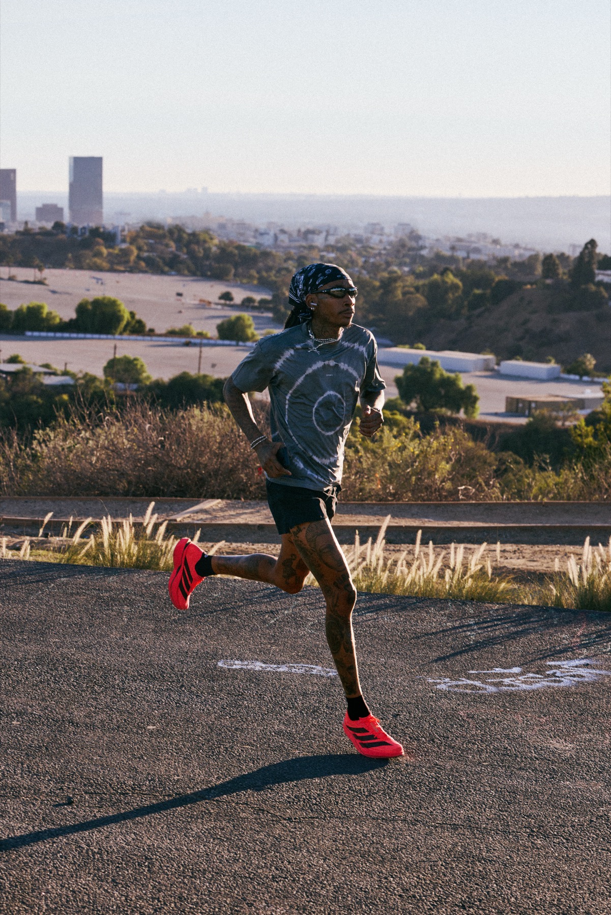 Wiz Khalifa running a ridge road above Los Angeles