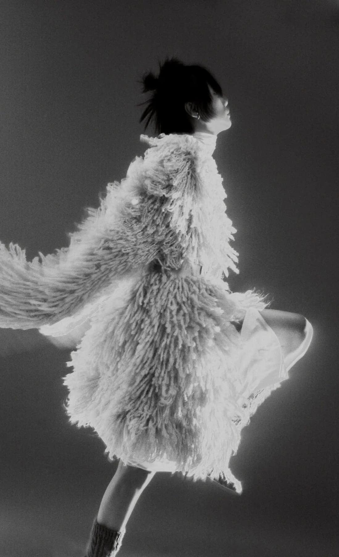 Model spinning in a long white shaggy fur coat with the hem flaring out